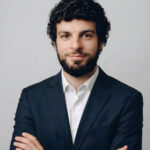 navy suit, grey studio background