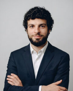 navy suit, grey studio background