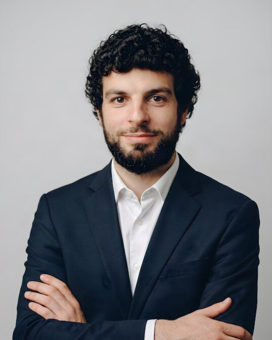 navy suit, grey studio background