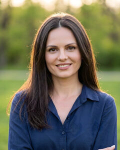 woman with long brown hair in dark blue shirt